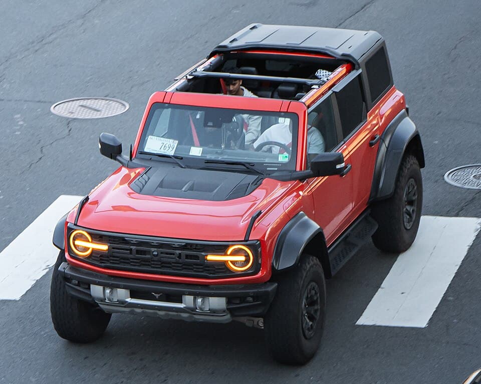Red Bronco Raptor (U725) with the roof panels removed, shot from above on a Washington DC-area street.