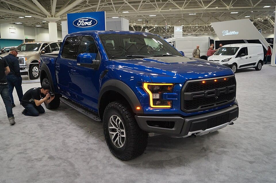 Blue 2017 Raptor on the Ford stand at the 2016 Twin Cities Auto Show, front three-quarter — the second-gen truck at its first show circuit.