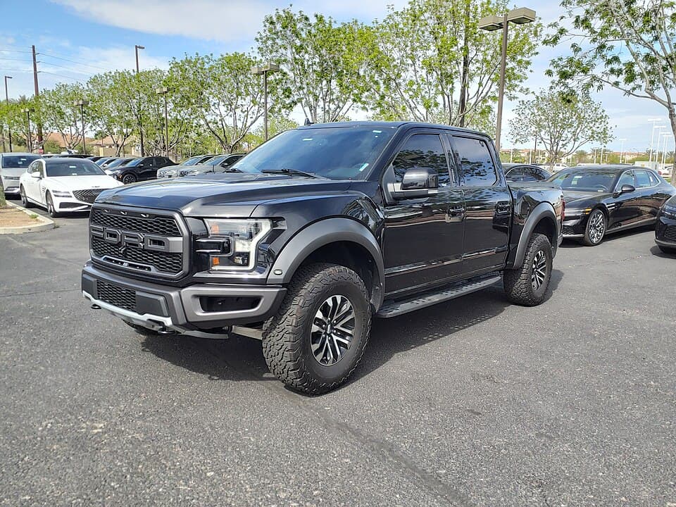 Black 2019 Raptor on a dealer lot in Gilbert, Arizona, front three-quarter — stock wheels, stock ride height.