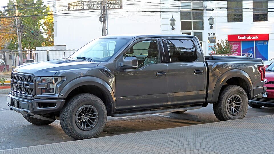 Grey 2020 Raptor SuperCrew on a street in Chile, front three-quarter, factory wheels and running boards.