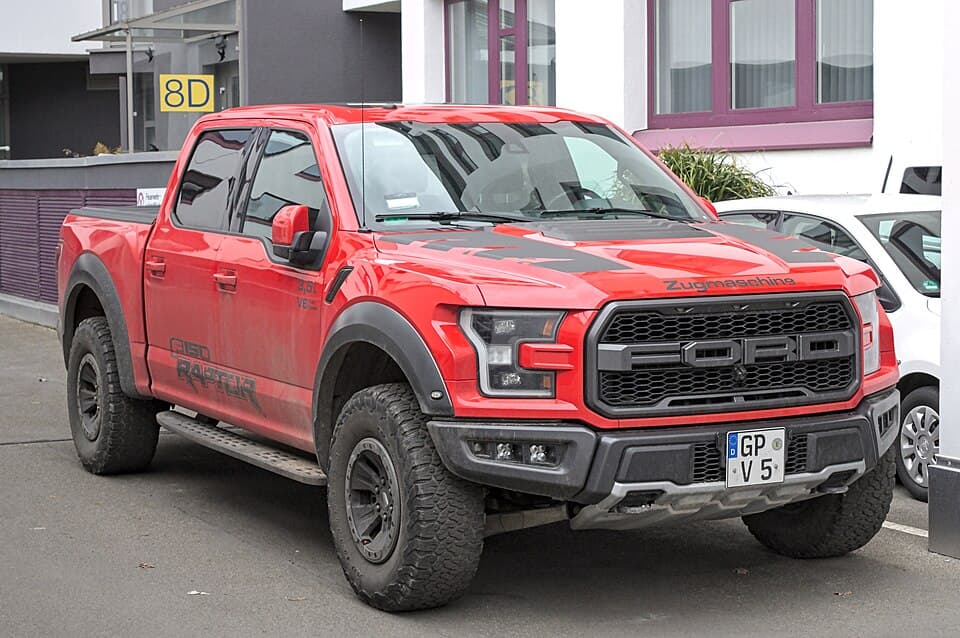Red second-gen Raptor parked on a Stuttgart street, side-on three-quarter, on factory wheels and tyres.