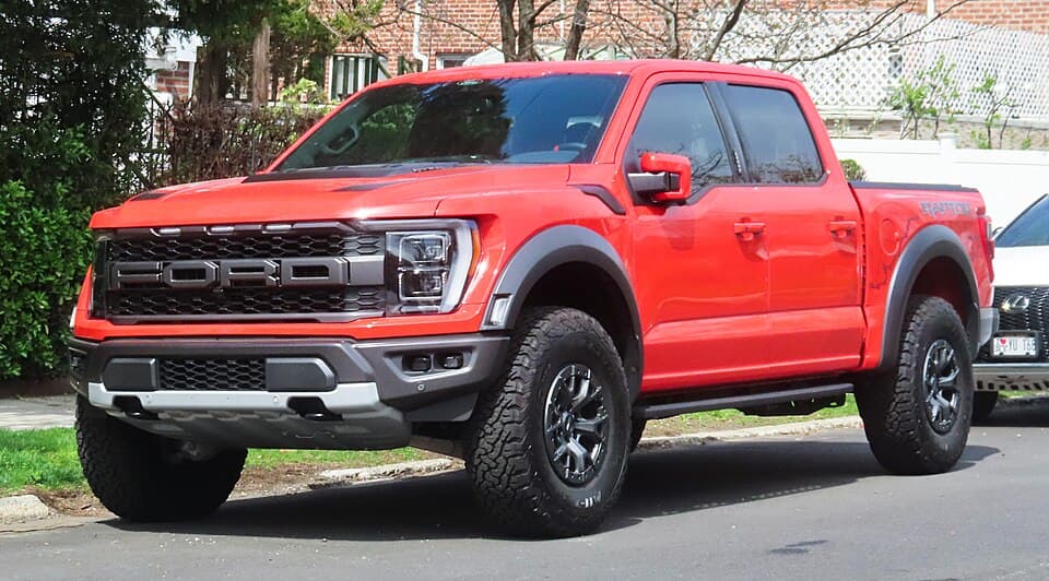 Code Orange 2021 Raptor SuperCrew photographed in Fresh Meadows, Queens, front three-quarter — the P702 truck on its factory 35s.
