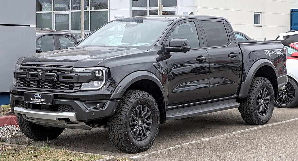 Black next-gen Ranger Raptor (P703) in Böblingen, front three-quarter with the C-clamp DRLs and the FORD block-letter grille.