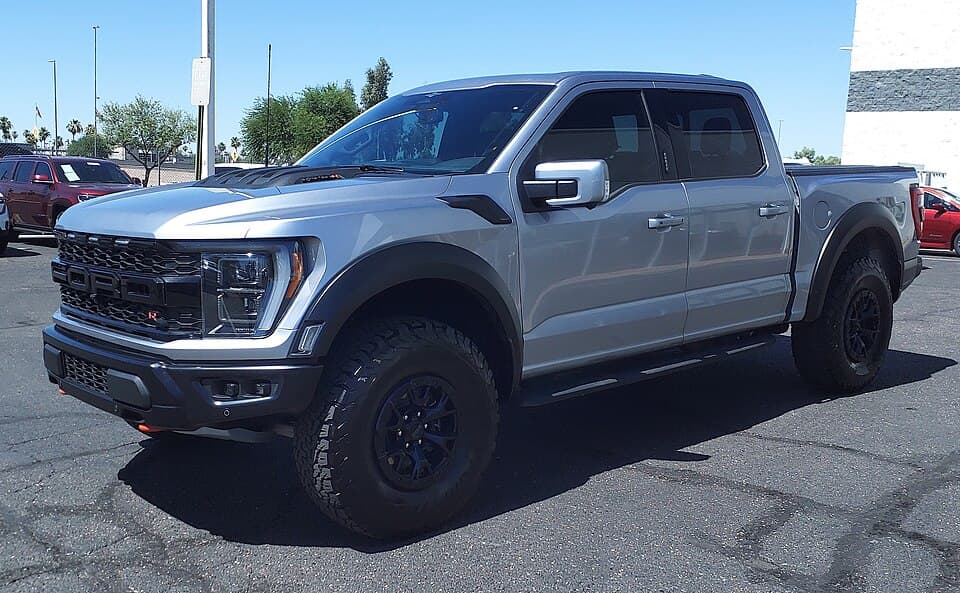 Tighter crop of the same 2023 Raptor R, front three-quarter — clearer view of the grille R badge and the raised hood vent.
